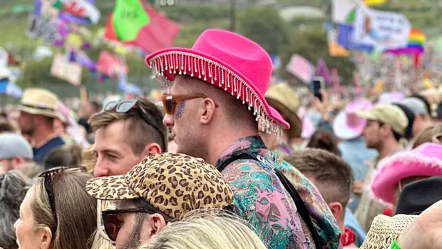 A man with a pink cowboy hat