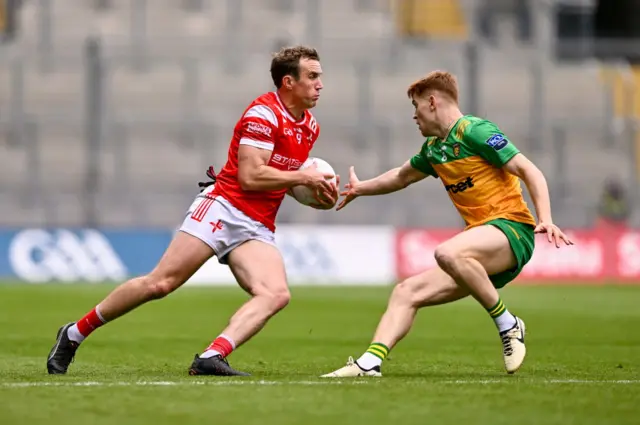 Bevan Duffy of Louth in action against Ciaran Moore of Donegal