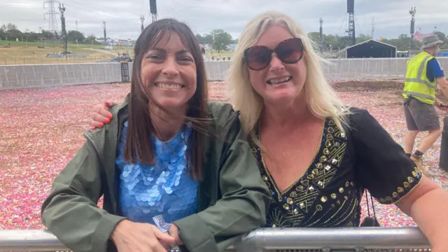 Two women at the Pyramid Stage early morning