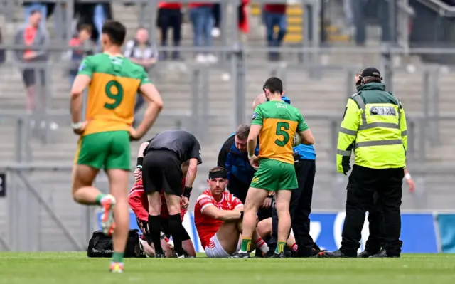 Sam Mulroy of Louth receives medical attention after a head injury