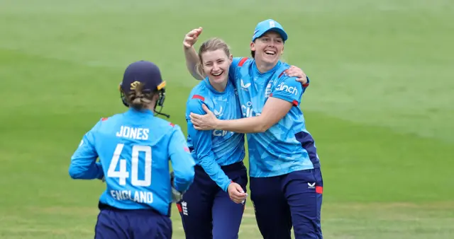 Charlie Dean celebrates the wicket of Maddy Green