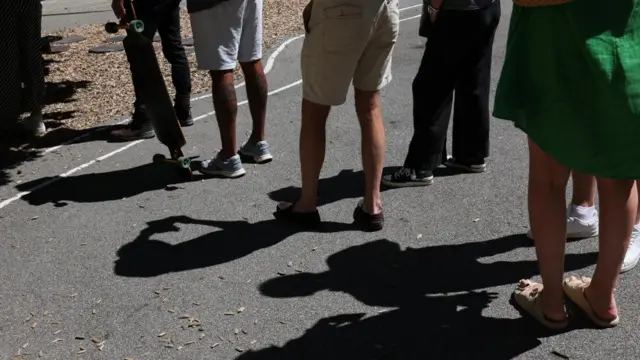 People stand in line to cast ballots