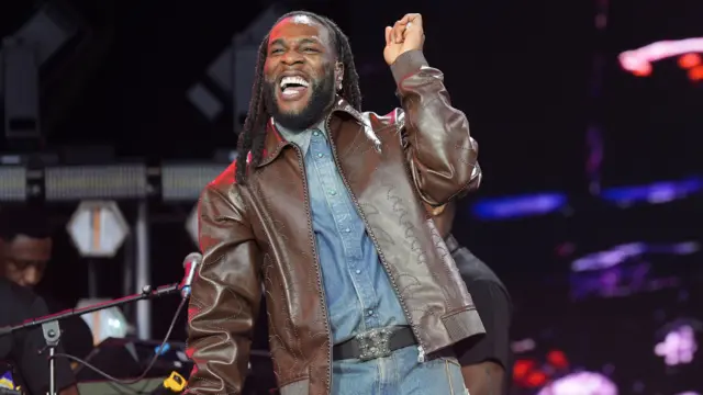 Burna Boy dances to the music on stage