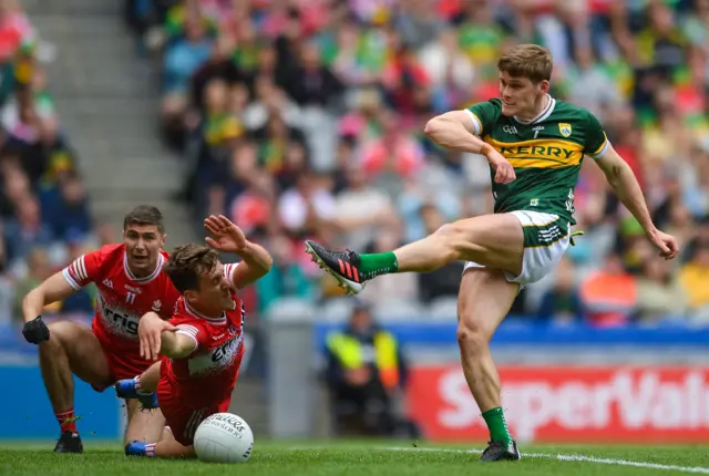 Gavin White of Kerry has his shot blocked by Shane McGuigan of Derry