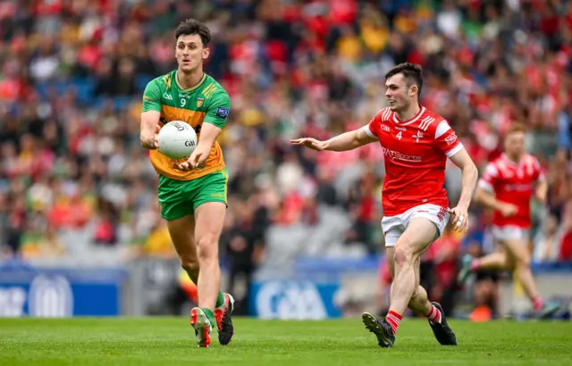 Michael Langan of Donegal with Ciaran Keenan of Louth