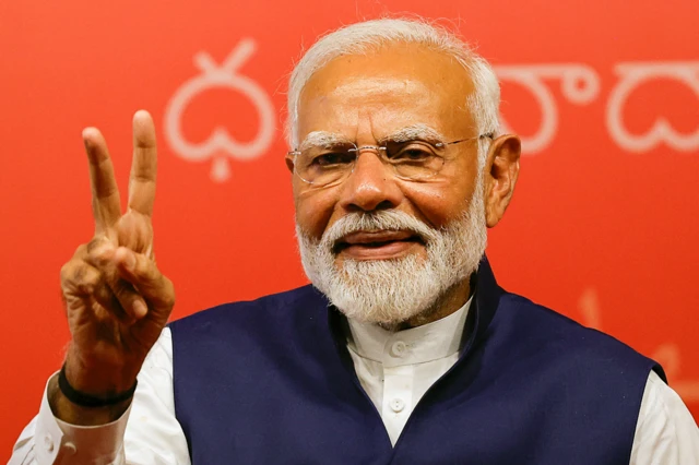 Narendra Modi gesturing to supporters at the BJP headquarters in Delhi