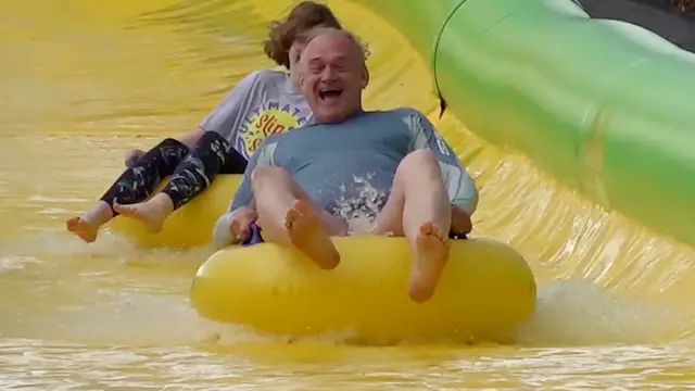 Davey laughs as he slides along on a rubber ring