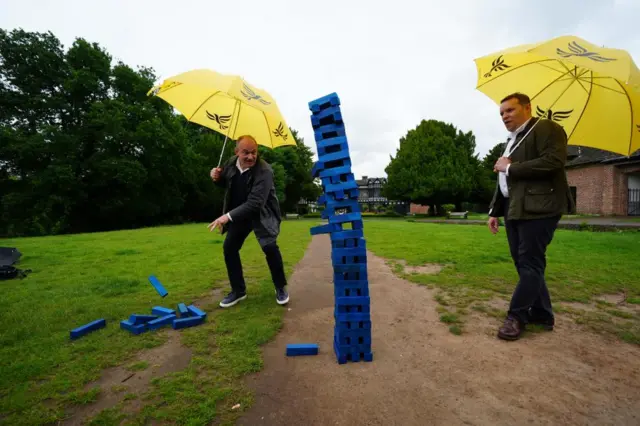 Liberal Democrats leader Sir Ed Davey and Liberal Democrat Parliamentary Candidate for Cheadle, Tom Morrison play Jenga during a visit to Cheadle, Greater Manchester, while on the General Election campaign trail.