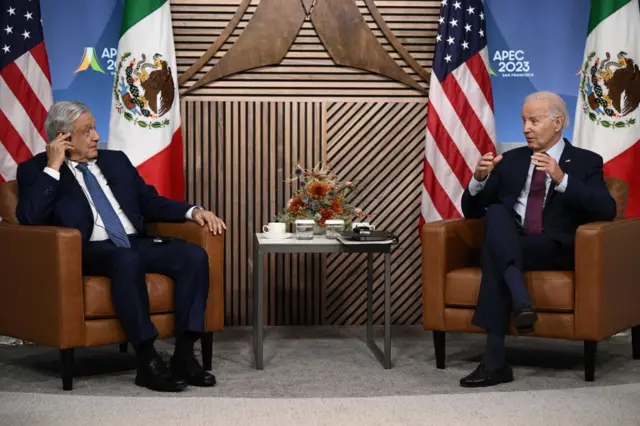 Mexican President Andres Manuel Lopez Obrador (L) speaks with US President Joe Biden in 2023