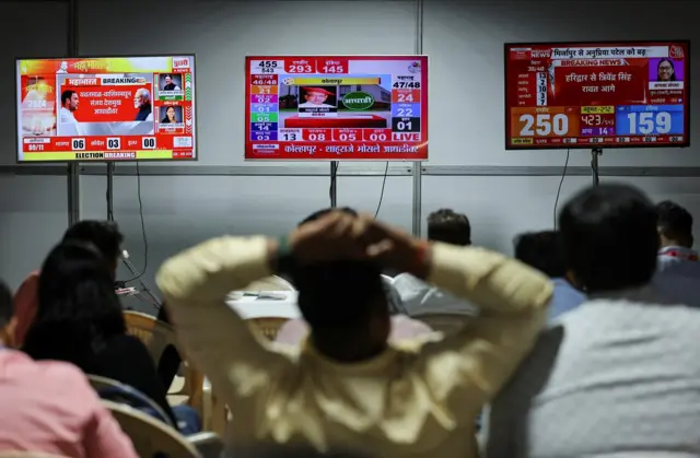 People watch election results outside a vote counting centre in Mumbai, India, June 4, 2024