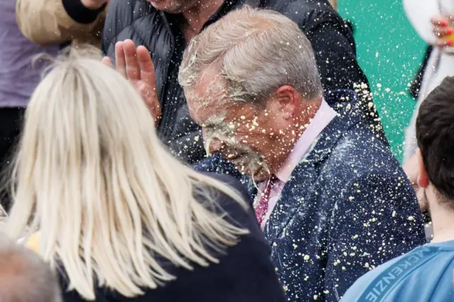 Nigel Farage (C), leader of Reform UK party and prospective parliamentary candidate for Clacton, reacts after a young woman threw a milkshake at him, during a campaign event in Clacton-on-sea, Essex, Britain, 04 June 2024.