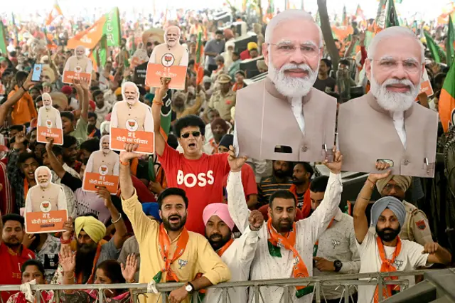 Supporters of the ruling Bharatiya Janta Party (BJP) holding cut-outs of India's Prime Minister and their leader, Narendra Modi shout slogans during an election campaign rally of their president and election candidate Jagat Prakash Nadda (not pictured), in Amritsar on May 30, 2024