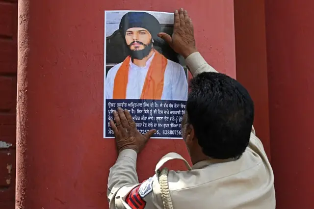 Police stick Amritpal Singh's poster at a railway station in Amritsar on April 13, 2023