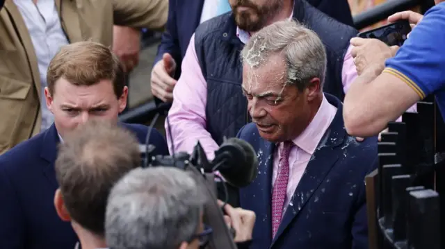 Nigel Farage seen covered in a drink