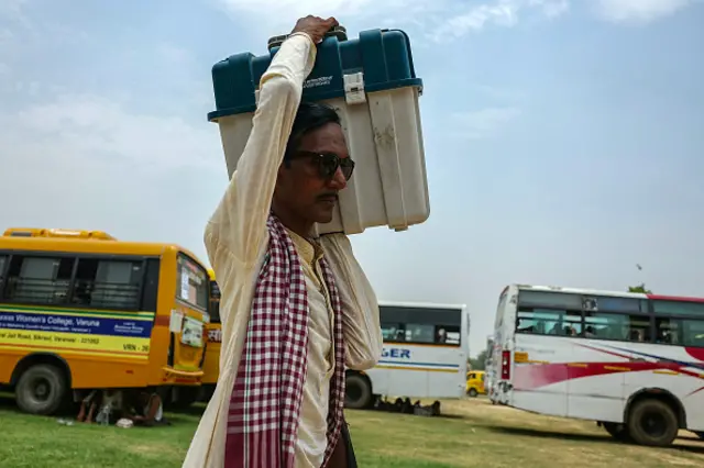 A polling official leaves after collecting Voter Verifiable Paper Audit Trail (VVPAT) machine and other voting materials at a distribution centre in Varanasi on May 31, 2024,