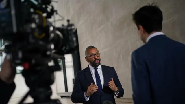 Home Secretary James Cleverly being interviewed