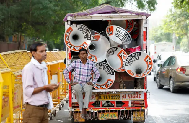 worker sits on the back of a truck carrying speakers that will be set up at the Bharatiya Janata Party (BJP) headquarters on the day of the general election results, in New Delhi, India, June 4, 2024