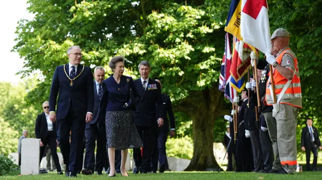 Princess Anne speaks to flag bearers as she arrives at the ceremony