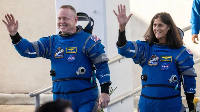 Members of the NASA Boeing Crew Flight Test Butch Wilmore (L) and Suni Williams (R), both of the National Aeronautics and Space Administration (NASA), walk out of the Neil A. Armstrong Operations