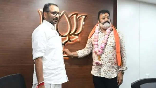 Suresh Gopi holds the BJP's lotus symbol at the party office in Kerala