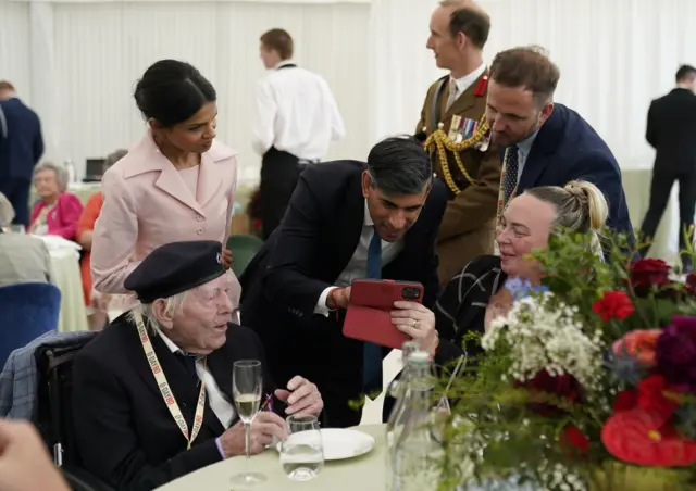 Pime Minister Rishi Sunak and his wife Akshata Murty meet 98-year-old veteran Frank Cooper at a D-Day commemoration event in Portsmouth