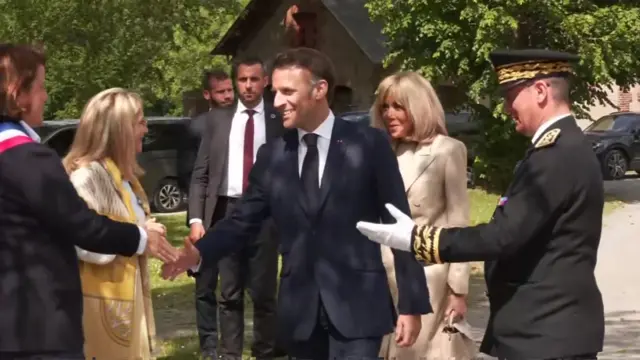 President Macron shakes hands with a local dignitary