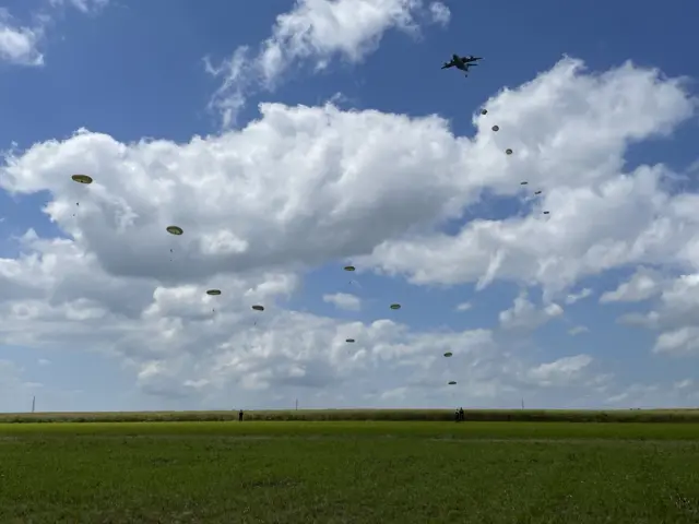 Paratroopers jumping from planes in a maize field east of Caen