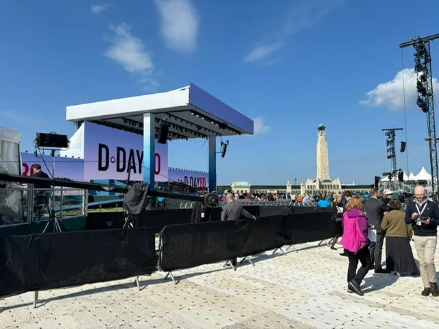 The D-Day 80 stage with Portsmouth Naval Memorial in the background against a clear blue sky