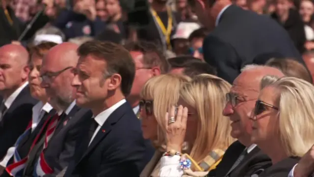 Emmanuel Macron sits with wife Brigitte Macron