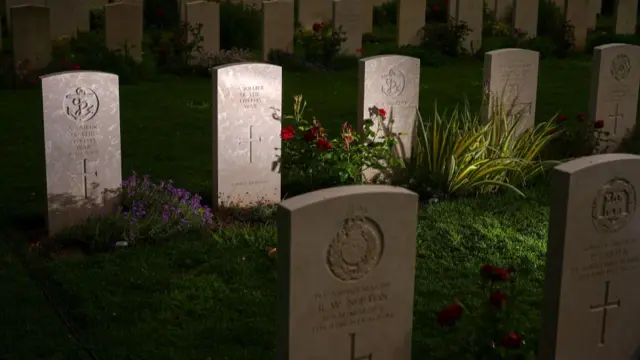 Graves of British soldiers, airmen and sailors are illuminated at the Bayeux British War Cemetery on June 03, 2024 in Bayeux, France