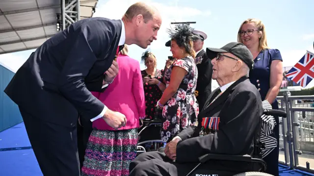 The Prince of Wales speaks to a veteran in a wheelchair