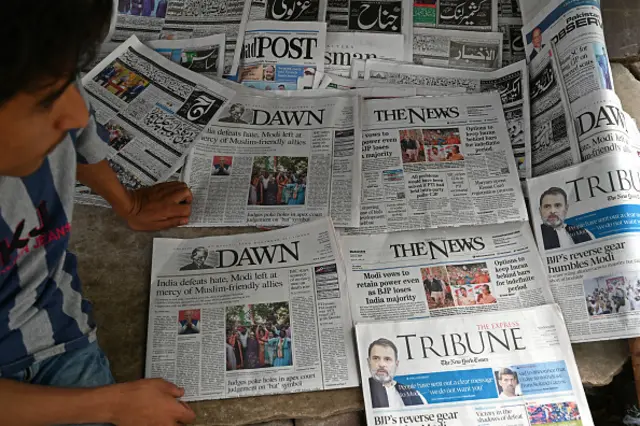 Pakistan's newspapers with front page of India's general election results are pictured along a street in Islamabad