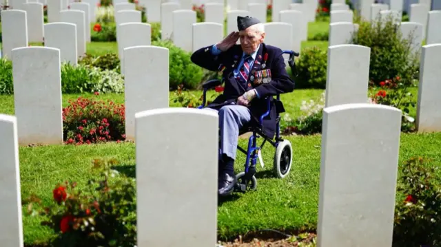 RAF veteran Bernard Morgan, 100, from Crewe, salutes the fallen at Bayeux War Cemetery in Normandy, France