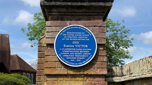 A blue plaque on the gate post at Station Victor to commemorate the work carried out there during World War Two