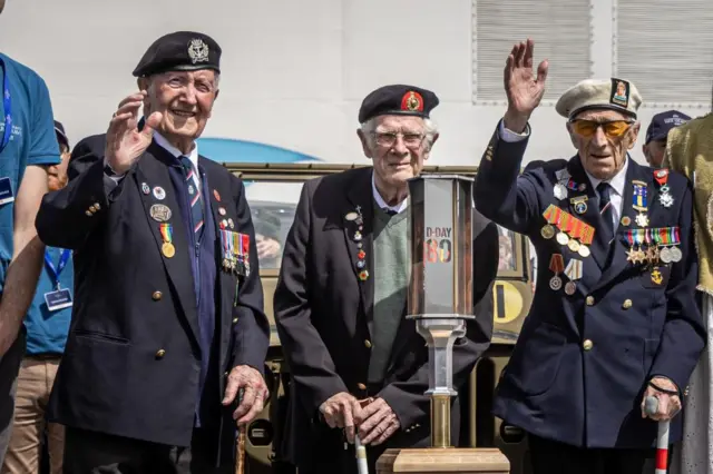 D-Day veterans Stan Ford (L), Alec Penstone (R) and Jim Grant (C) with the torch on Tuesday