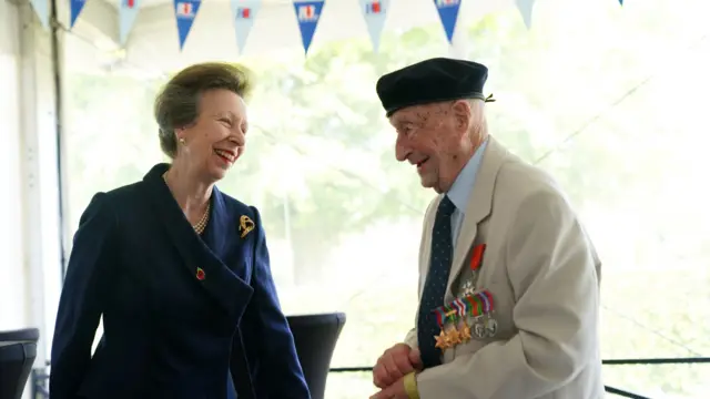 Princess Anne laughs with a veteran