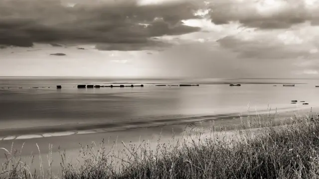 The remains of the D-Day 'Mulberry' artificial harbour at Arromanches, Normandy