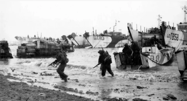 Archive D-Day picture of soldiers coming off landing craft