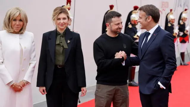French President's wife Brigitte Macron and France's President Emmanuel Macron greet Ukraine's President Volodymyr Zelensky and his wife Olena Zelenska upon their arrival to attend the International commemorative ceremony at Omaha Beach marking the 80th anniversary of the World War II "D-Day" Allied landings in Normandy, in Saint-Laurent-sur-Mer, in northwestern France, on June 6, 2024