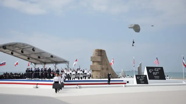 Young people attend a commemorative ceremony with dozens of heads of States and more than 200 veterans for the 80th anniversary of D-Day landings in Normandy at Omaha Beach
