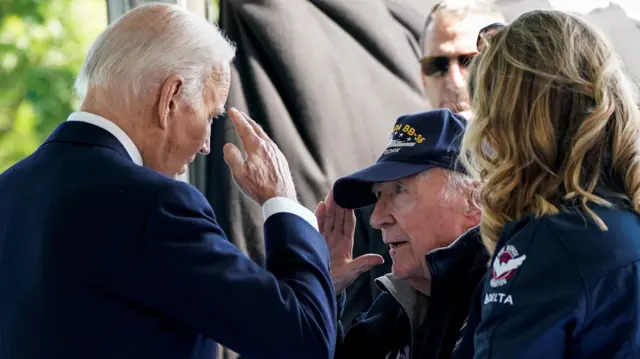 Joe Biden and a World War Two veteran salute each other