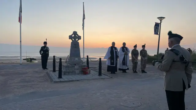 Military personnel at a service at sun rise