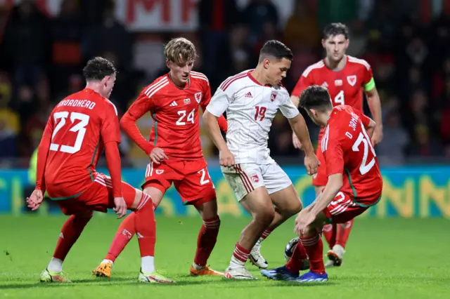 Wales v Gibraltar match action from the game in October, four Welsh players and one Gibraltar player challenging for the ball