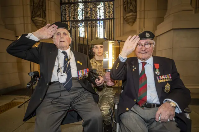 John Mitchell, left, saluting alongside Cyril Bird