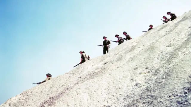 Colourised archive picture of soldiers of the 3rd Canadian Infantry Division on patrol near Juno Beach