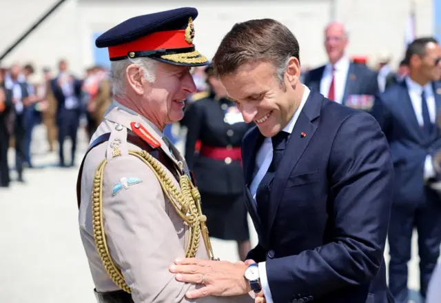 King Charles greets French President Emmanuel Macron during the UK Ministry of Defence and the Royal British Legion's commemorative event