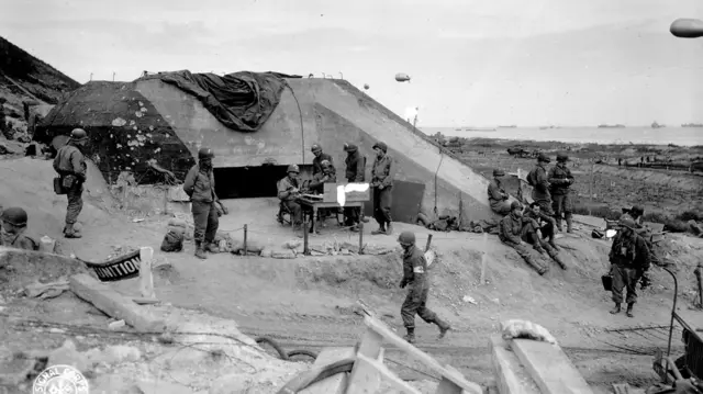 US troops at a captured German battery on Omaha beach