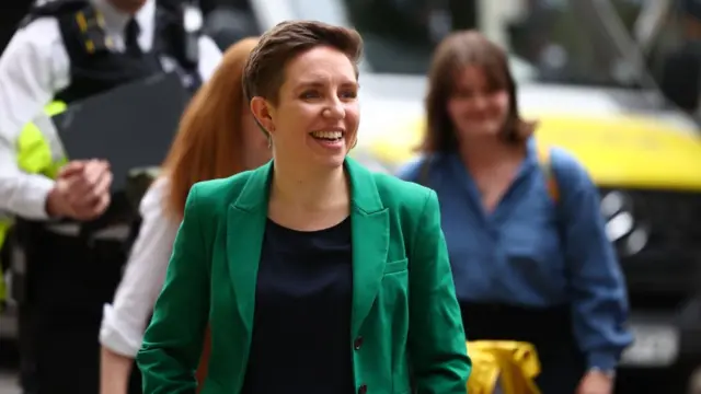 Carla Denyer wearing a green suit