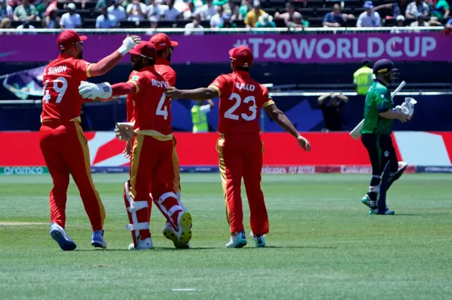 Canada celebrate the wicket of Paul Stirling