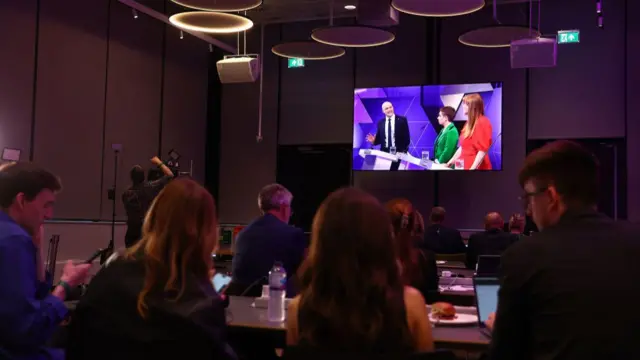 Journalists in a media room listen to the BBC election debate at BBC Broadcasting House